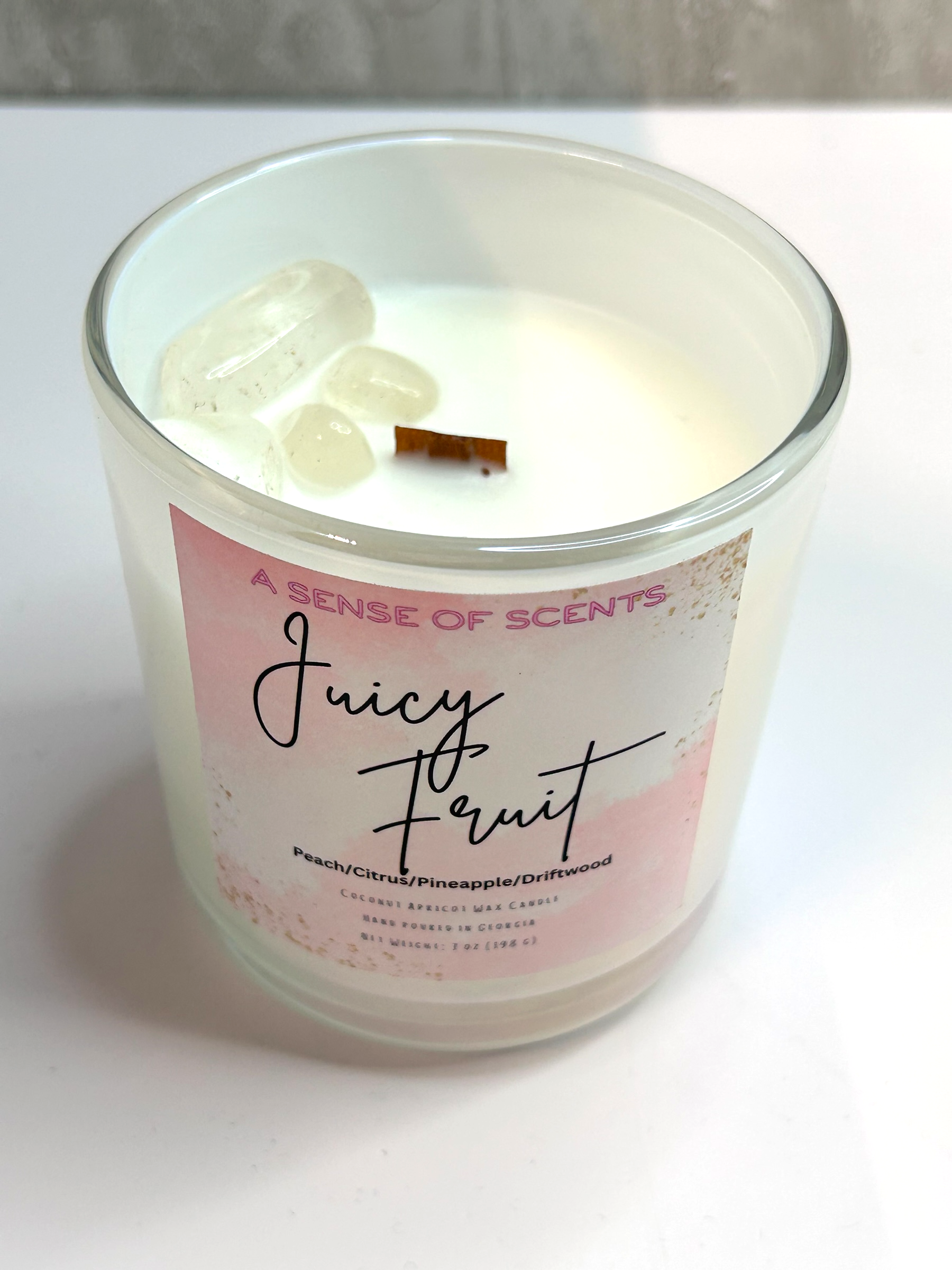 Candle with a 'Juicy Fruit' label on a white background