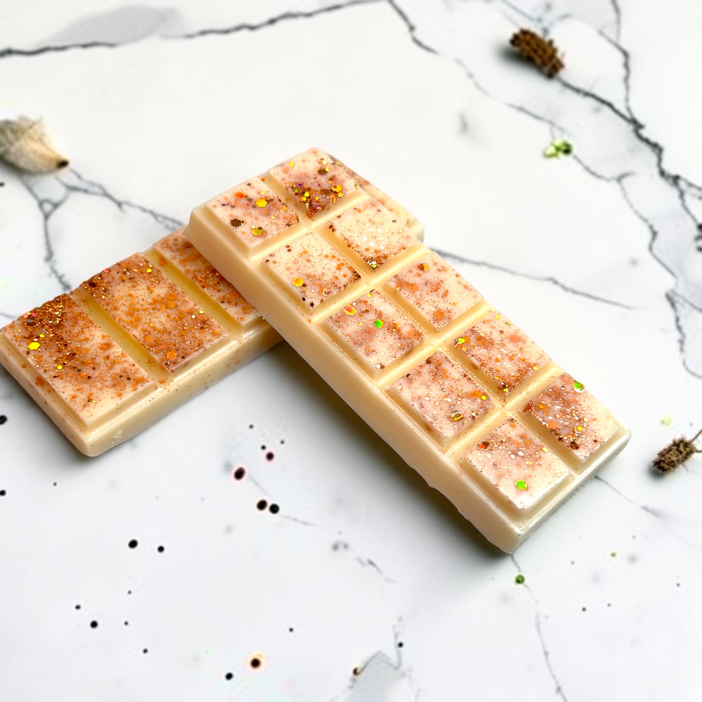 Coconut wax melt bar with specks on a marble surface