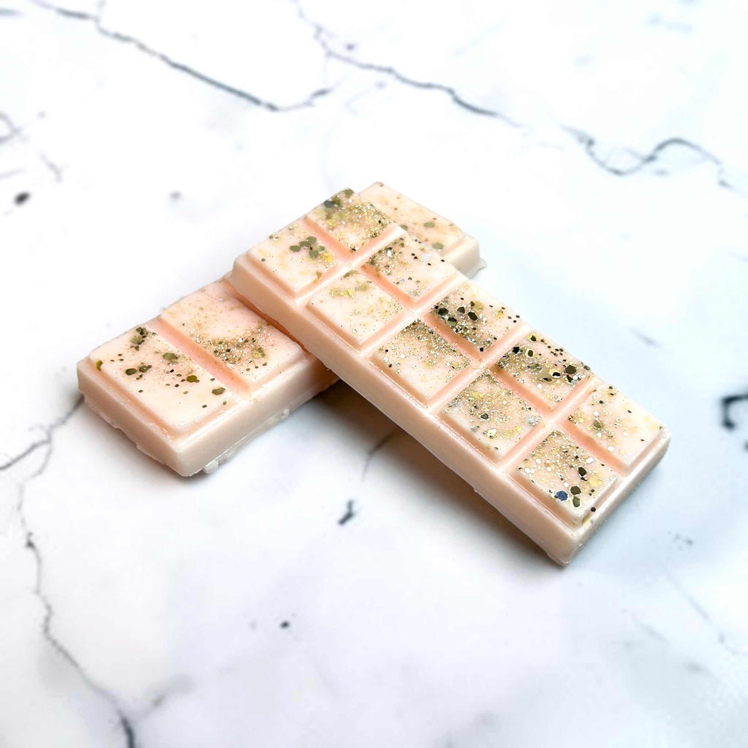 Two coconut was melts with speckled texture on a marble surface