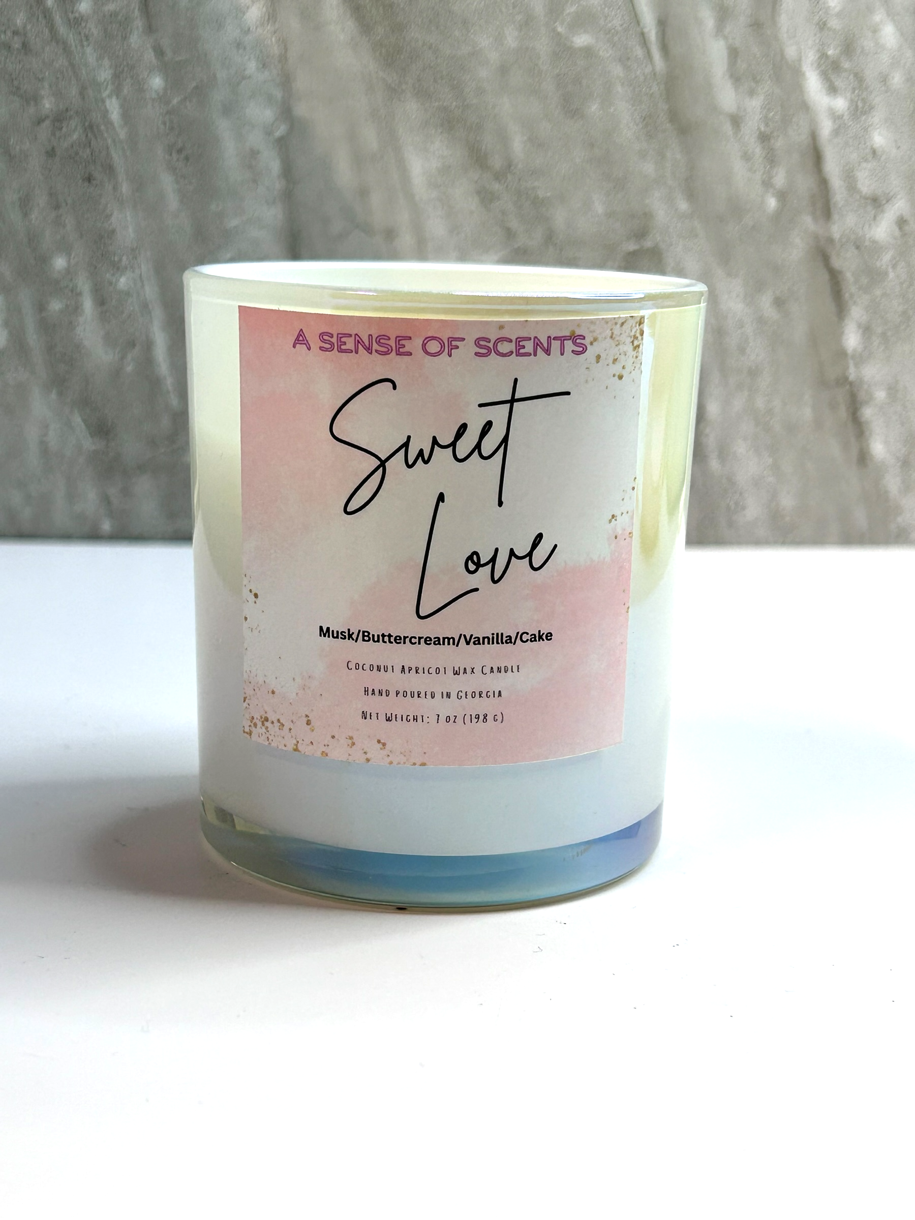 Candle with 'Sweet Love' label on a white surface