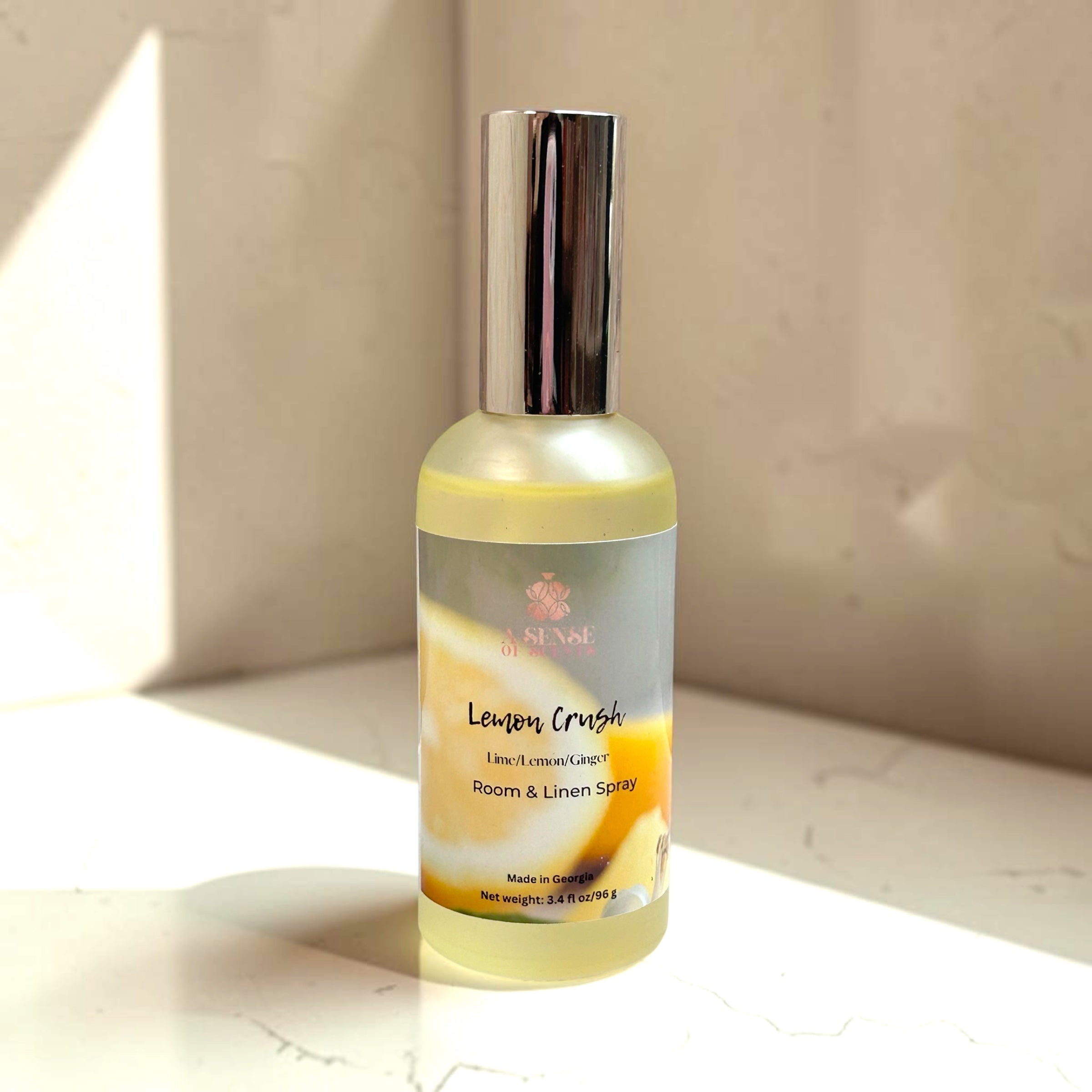 Bottle of Lemon Crush room and linen spray on a neutral background