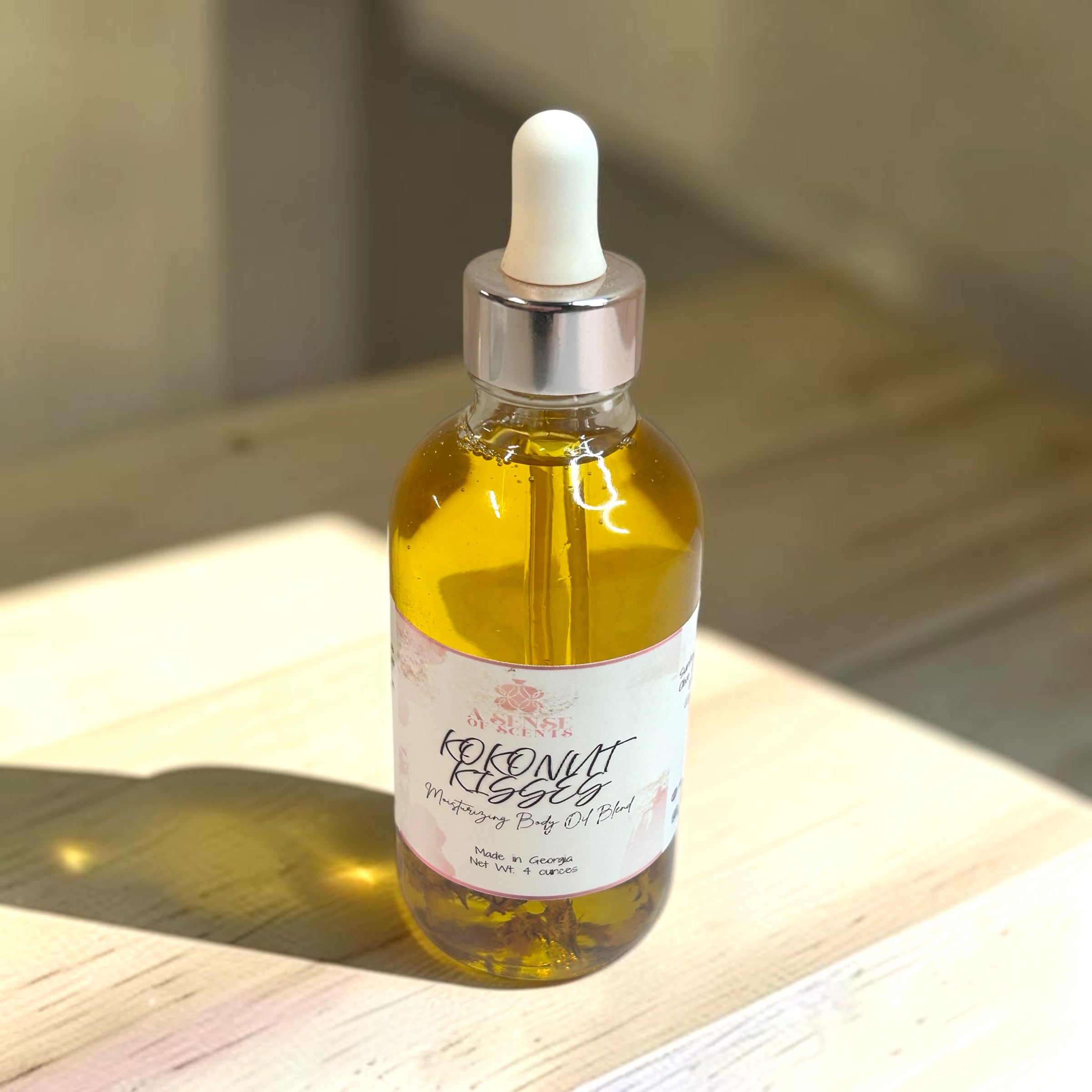 Bottle of coconut oil with a dropper on a wooden surface